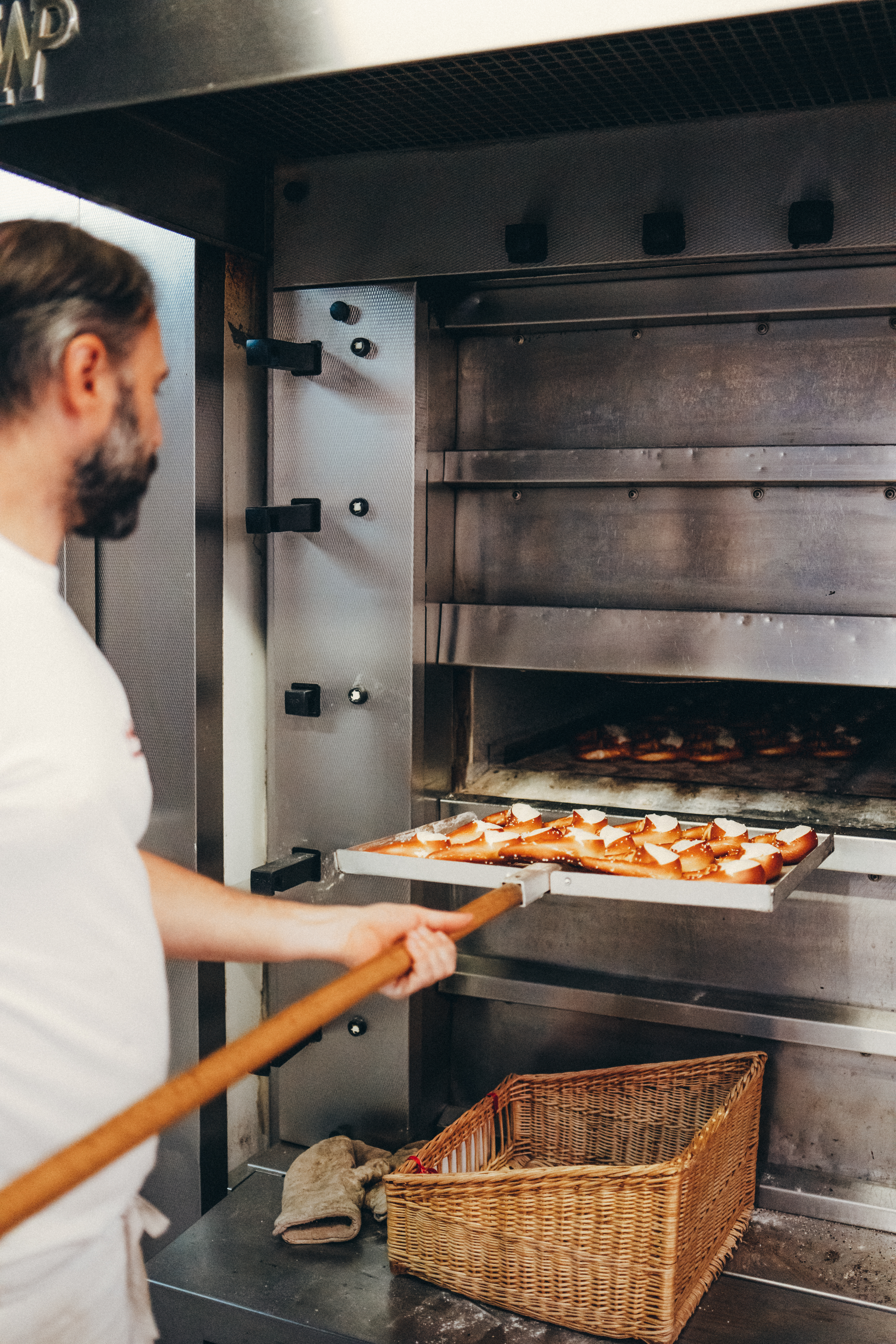 Bernd Dannenmann sliding pretzels into the oven